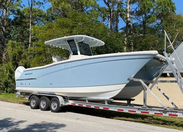 Wcn 51105 280ccx Coastbl Merc Yacht Photos Pics 2024 World Cat 280 CC-X boat on a trailer, parked outdoors.