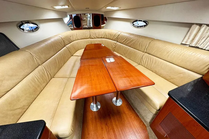 Section 117 Yacht Photos Pics Luxurious interior of 2011 Formula 370 Super Sport yacht with beige seating and wooden table.