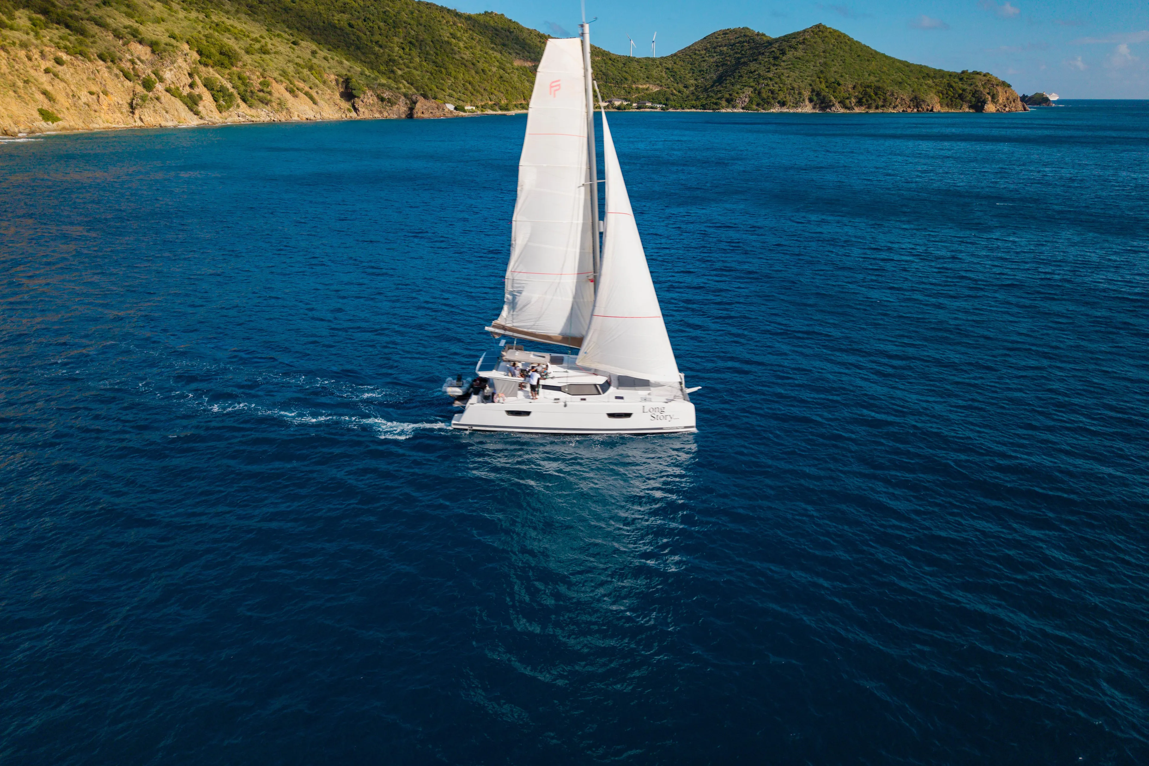 Long Story Yacht Photos Pics 2019 Fountaine Pajot Saona 47 sailing near lush green islands.