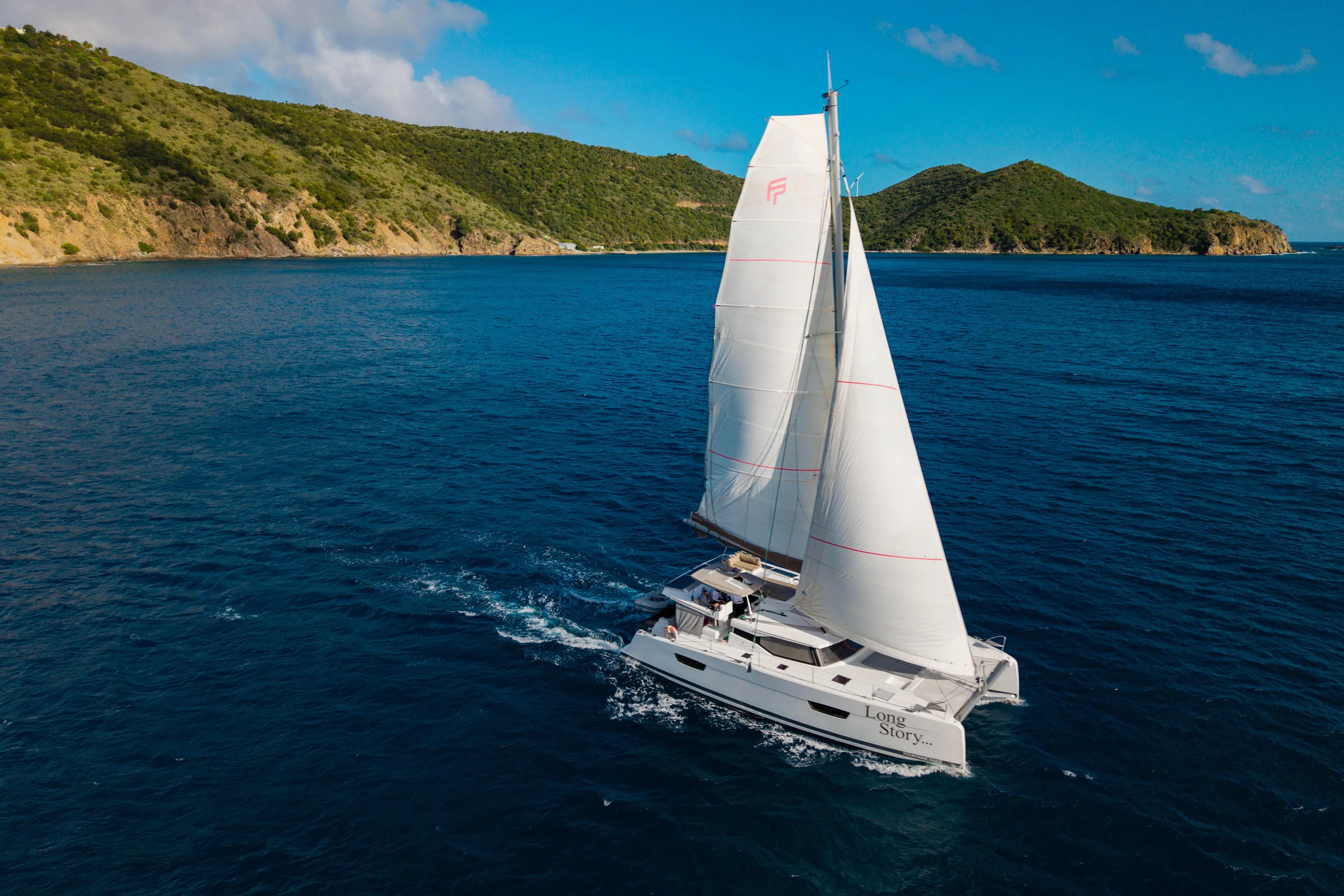 Long Story Yacht Photos Pics 2019 Fountaine Pajot Saona 47 sailing near lush green islands.