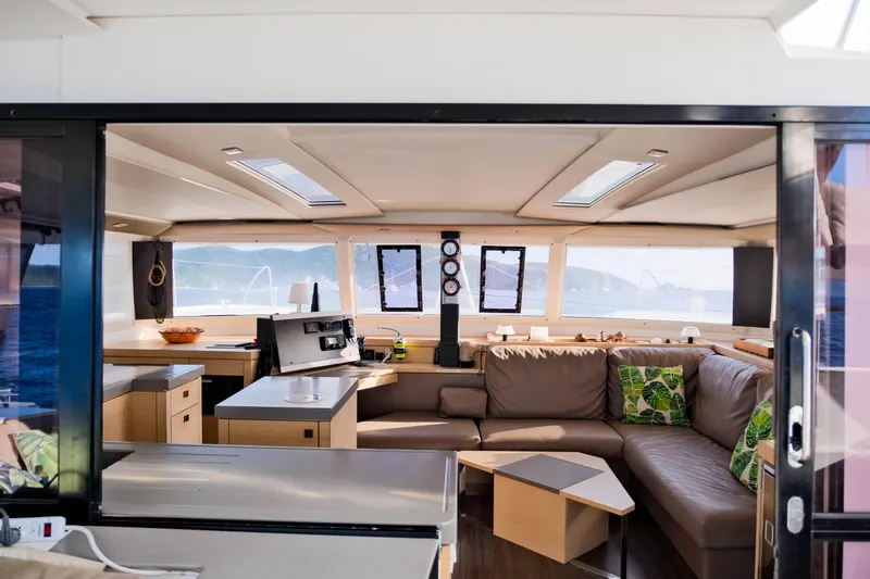 Long Story Yacht Photos Pics Luxurious interior of 2019 Fountaine Pajot Saona 47 catamaran with modern furnishings and ocean view.