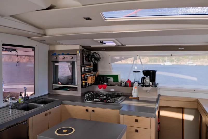 Long Story Yacht Photos Pics Modern kitchen interior of 2019 Fountaine Pajot Saona 47 catamaran with ocean view.
