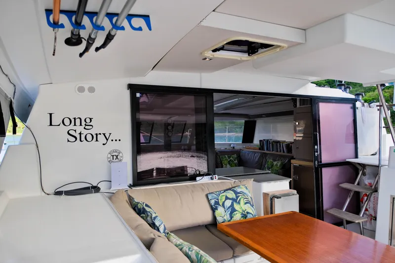 Long Story Yacht Photos Pics 2019 Fountaine Pajot Saona 47 yacht interior with seating, table, and "Long Story..." text.