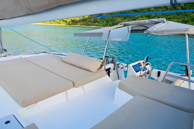 Long Story Yacht Photos Pics Luxurious 2019 Fountaine Pajot Saona 47 catamaran with sunbeds and scenic ocean view.