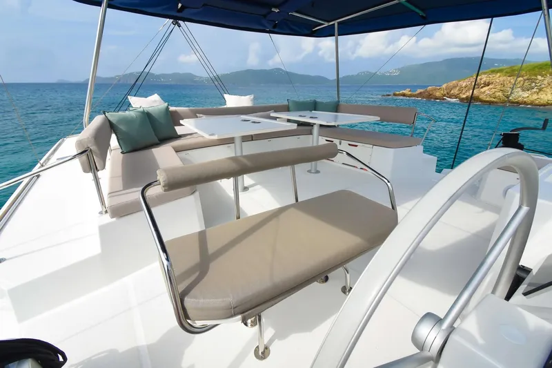 Nae Kae Yacht Photos Pics 2022 Bali 5.4 yacht deck with seating, tables, and ocean view.
