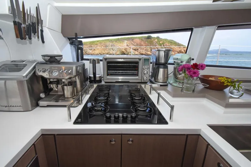 Nae Kae Yacht Photos Pics Modern kitchen in a 2022 Bali 5.4 yacht with appliances and ocean view.