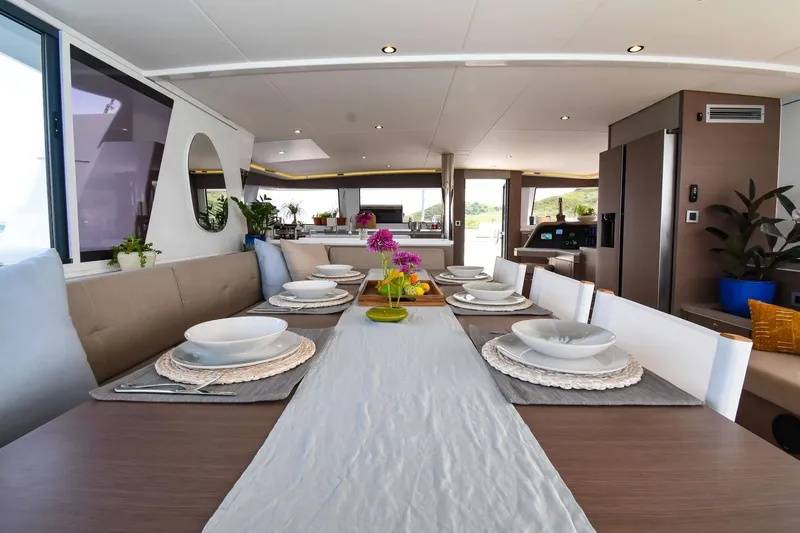 Nae Kae Yacht Photos Pics Luxurious dining area on 2022 Bali 5.4 yacht, elegantly set table with modern decor.