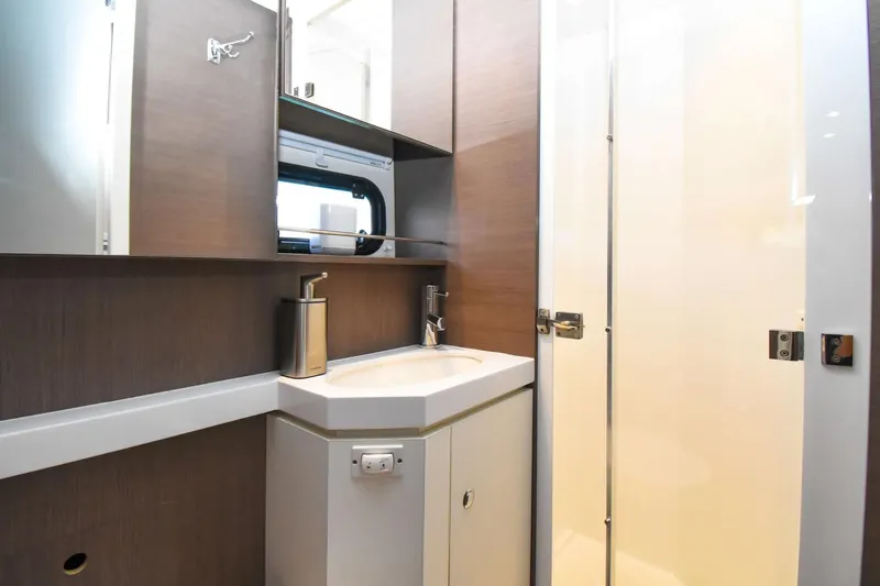 Nae Kae Yacht Photos Pics Modern bathroom interior on 2022 Bali 5.4 yacht, featuring sleek sink and mirror.