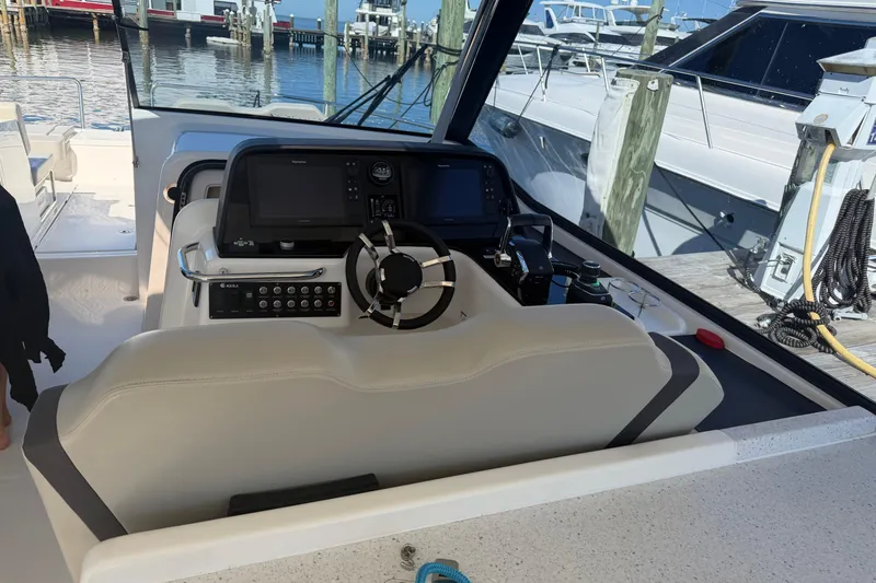 Chasin' Hyde Yacht Photos Pics Helm of 2023 Aquila 36 Sport boat with modern controls and steering wheel.