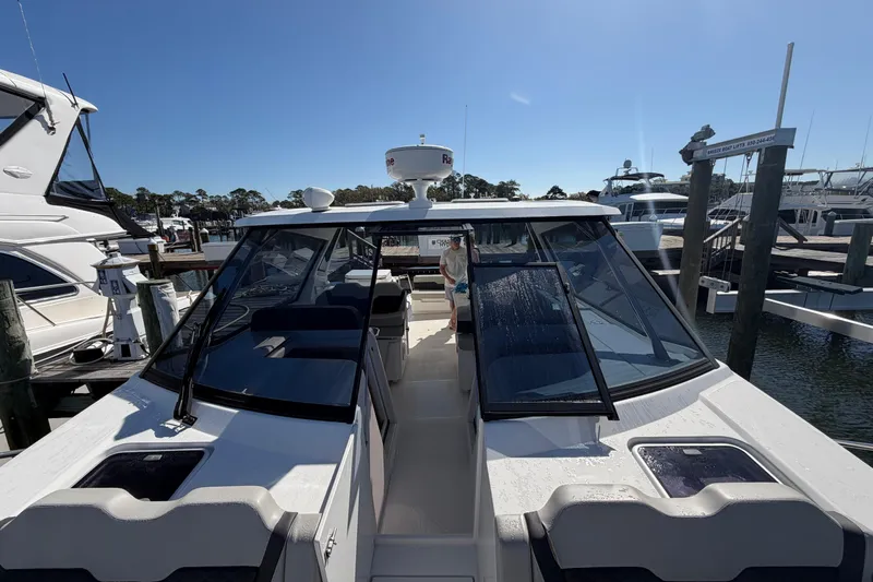 Chasin' Hyde Yacht Photos Pics 2023 Aquila 36 Sport boat docked at marina under clear blue sky.