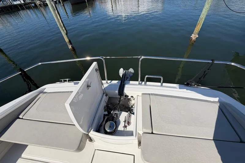 Chasin' Hyde Yacht Photos Pics 2023 Aquila 36 Sport boat deck with open storage compartment and water view.