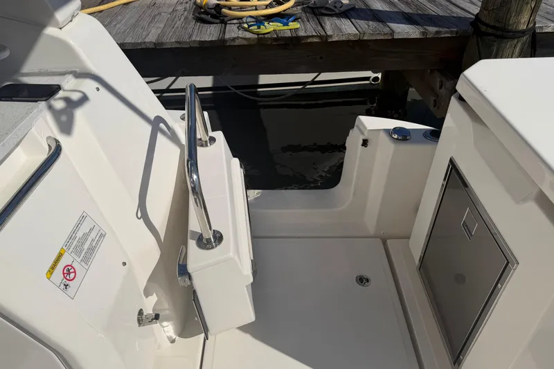 Chasin' Hyde Yacht Photos Pics 2023 Aquila 36 Sport boat interior with stainless steel railing and storage compartment.