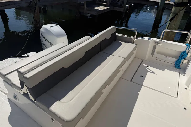 Chasin' Hyde Yacht Photos Pics 2023 Aquila 36 Sport boat with spacious seating and Mercury engine at dock.