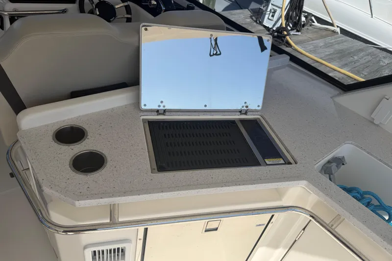 Chasin' Hyde Yacht Photos Pics 2023 Aquila 36 Sport boat interior with kitchenette and grill setup.