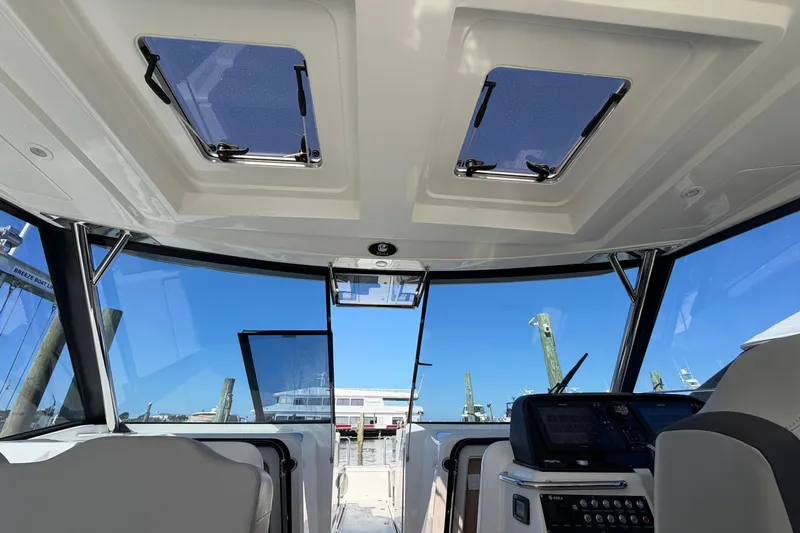 Chasin' Hyde Yacht Photos Pics Interior view of 2023 Aquila 36 Sport boat cockpit with modern controls and skylights.