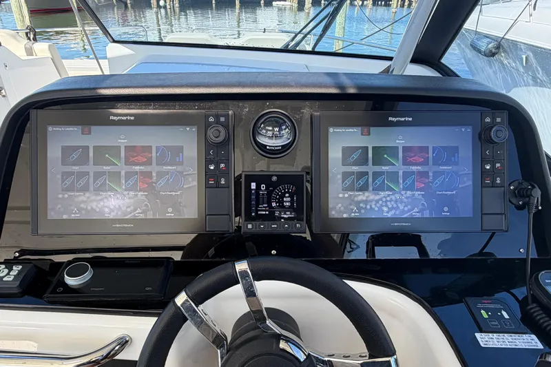 Chasin' Hyde Yacht Photos Pics Helm of 2023 Aquila 36 Sport with dual Raymarine displays and steering wheel.