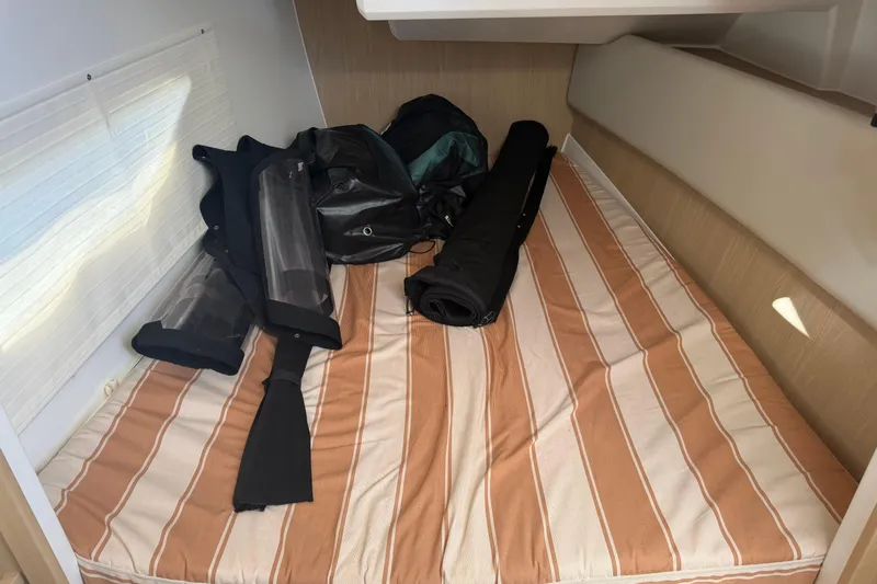Chasin' Hyde Yacht Photos Pics Interior cabin of 2023 Aquila 36 Sport with striped bedding and gear.