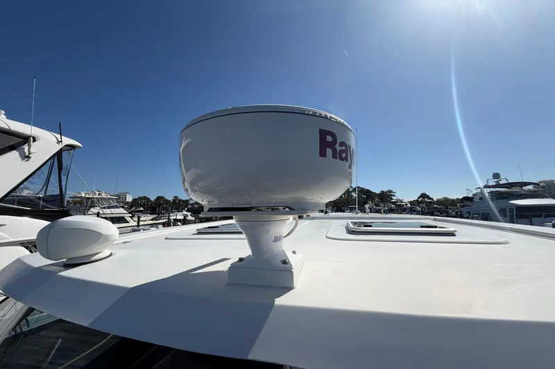 Chasin' Hyde Yacht Photos Pics 2023 Aquila 36 Sport yacht with Raymarine radar on deck under clear blue sky.