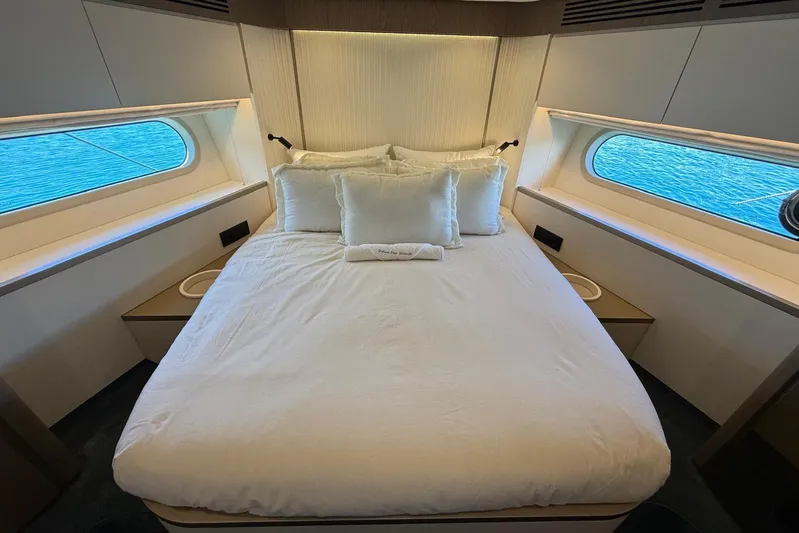 Dolce Far Niente Yacht Photos Pics Luxurious bedroom interior of 2024 Azimut Magellano 60 yacht with ocean view windows.