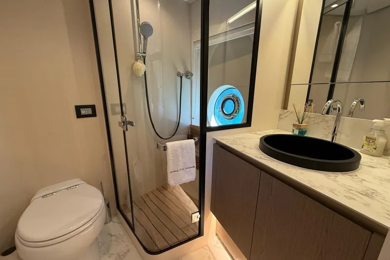 Dolce Far Niente Yacht Photos Pics Luxurious bathroom in 2024 Azimut Magellano 60 yacht, featuring modern fixtures and elegant design.