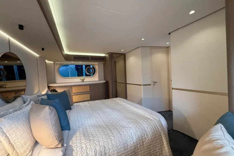 Dolce Far Niente Yacht Photos Pics Luxurious bedroom interior of 2024 Azimut Magellano 60 yacht with elegant decor.