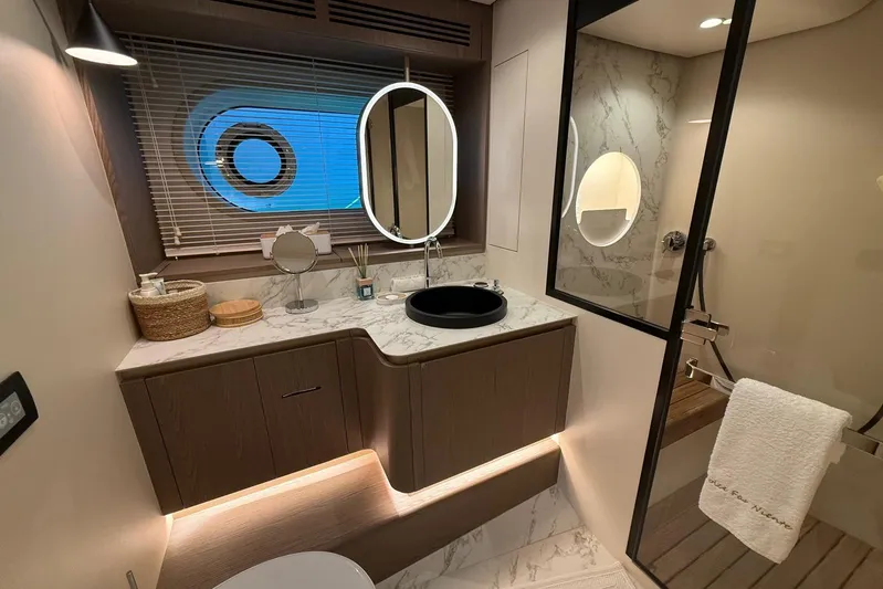 Dolce Far Niente Yacht Photos Pics Luxurious bathroom interior of 2024 Azimut Magellano 60 yacht with modern fixtures and elegant design.