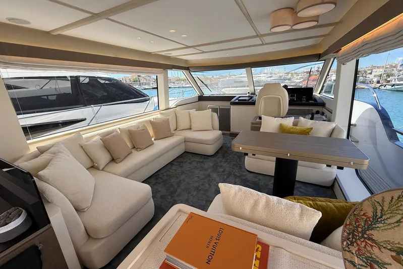 Dolce Far Niente Yacht Photos Pics Luxurious interior of 2024 Azimut Magellano 60 yacht with plush seating and panoramic windows.