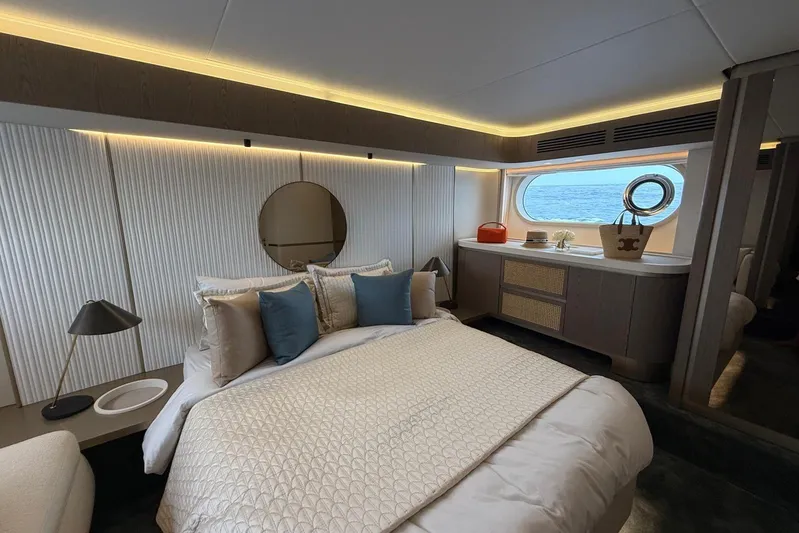 Dolce Far Niente Yacht Photos Pics Luxurious bedroom interior of 2024 Azimut Magellano 60 yacht with ocean view window.
