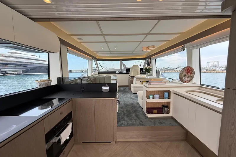 Dolce Far Niente Yacht Photos Pics Luxurious interior of 2024 Azimut Magellano 60 yacht with modern kitchen and panoramic views.