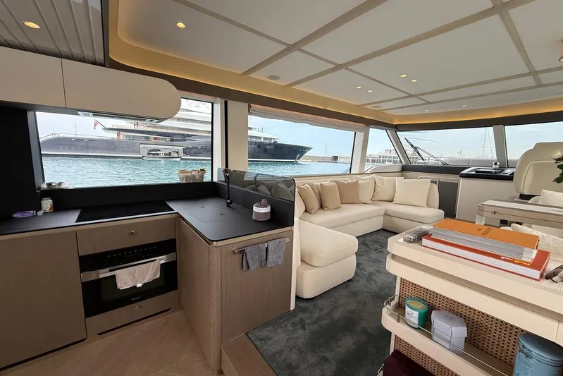 Dolce Far Niente Yacht Photos Pics Luxurious interior of 2024 Azimut Magellano 60 yacht with modern kitchen and spacious seating area.