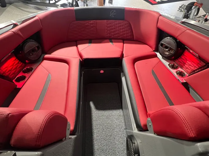  Yacht Photos Pics Luxurious red interior of 2025 MasterCraft X24 boat with premium seating and speakers.