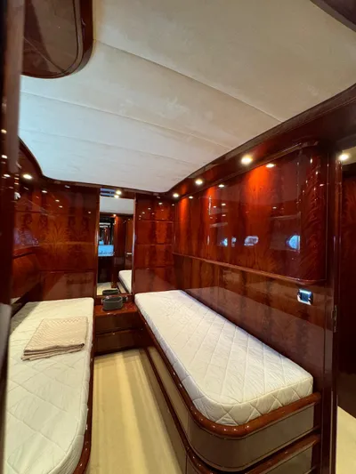  Yacht Photos Pics Luxurious cabin interior of 2003 Astondoa 82 yacht with twin beds and elegant wood finish.