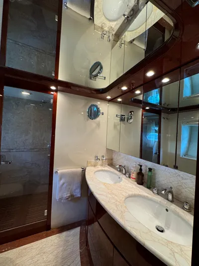  Yacht Photos Pics Luxurious bathroom in 2003 Astondoa 82 yacht with dual sinks and elegant wood finishes.