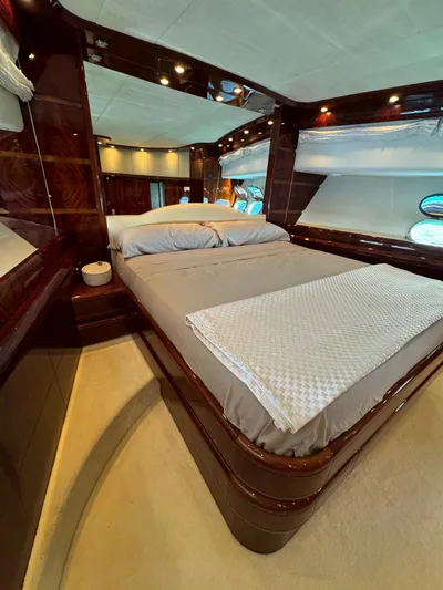  Yacht Photos Pics Luxurious bedroom interior of 2003 Astondoa 82 yacht with elegant wood finishes.