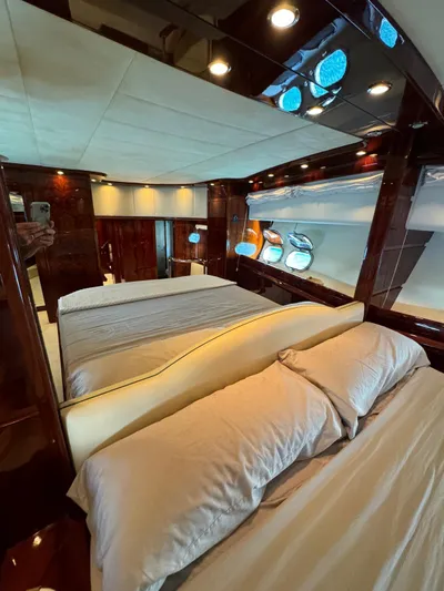  Yacht Photos Pics Luxurious bedroom interior of 2003 Astondoa 82 yacht with elegant wood finishes.