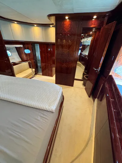  Yacht Photos Pics Luxurious interior of a 2003 Astondoa 82 yacht, featuring elegant wood finishes and plush bedding.