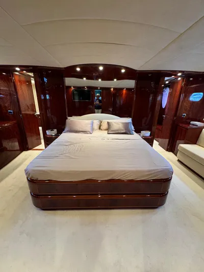  Yacht Photos Pics Luxurious bedroom interior of 2003 Astondoa 82 yacht with elegant wood finishes.