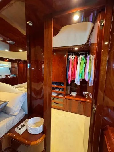  Yacht Photos Pics Luxurious cabin interior of 2003 Astondoa 82 yacht with wood finishes and closet space.