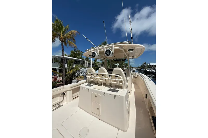  Yacht Photos Pics 2021 Grady-White Canyon 336 boat, spacious deck, palm trees, clear blue sky.