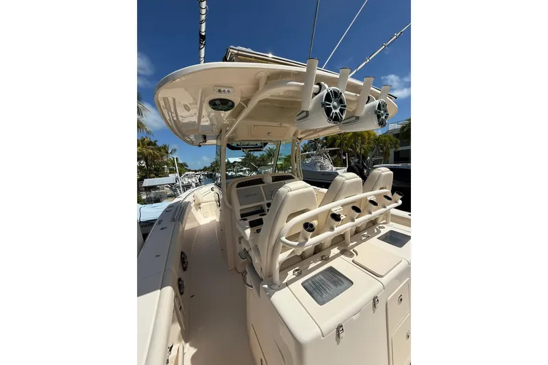  Yacht Photos Pics 2021 Grady-White Canyon 336 boat interior with helm and seating under clear blue sky.