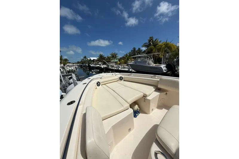  Yacht Photos Pics 2021 Grady-White Canyon 336 boat interior with seating, docked under clear blue sky.