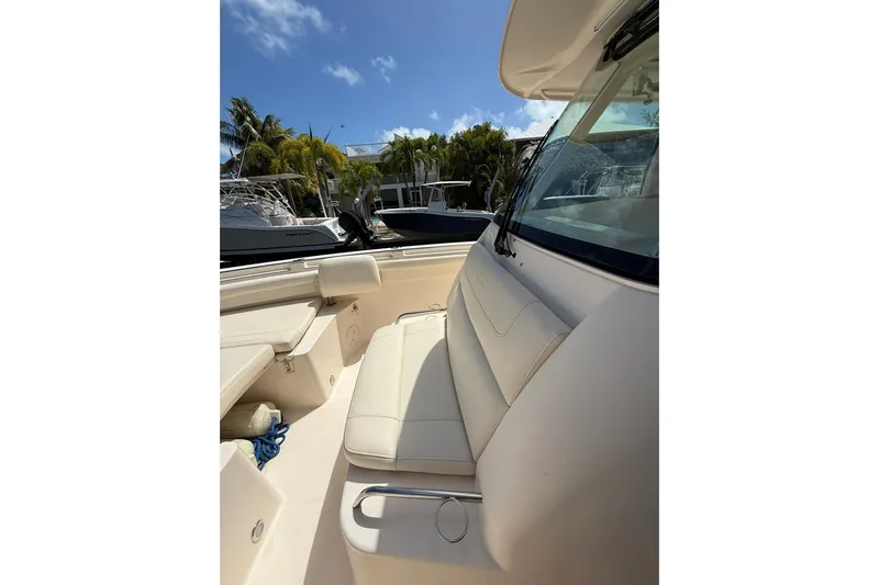  Yacht Photos Pics 2021 Grady-White Canyon 336 boat interior with seating, docked under clear sky.