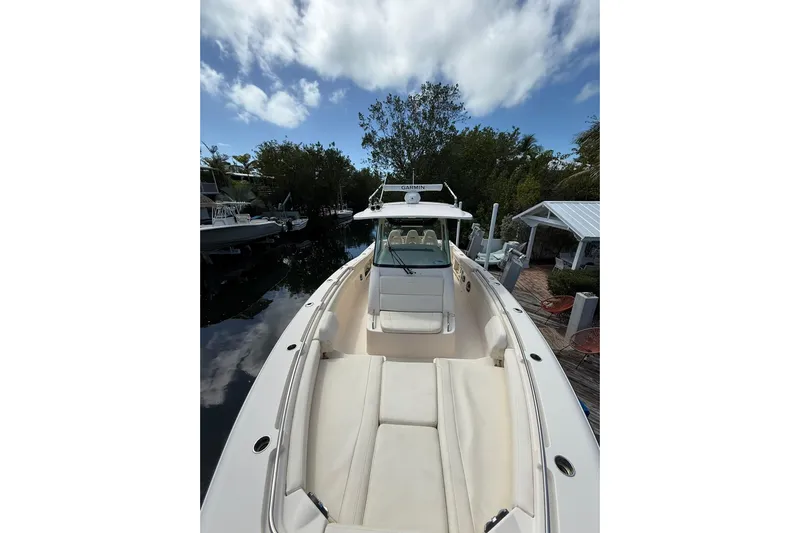  Yacht Photos Pics 2021 Grady-White Canyon 336 boat docked, featuring spacious seating and clear skies.