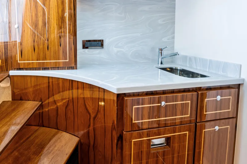  Yacht Photos Pics Luxurious wooden cabinetry and sleek sink in 2025 HCB 56 Suenos GIX yacht interior.