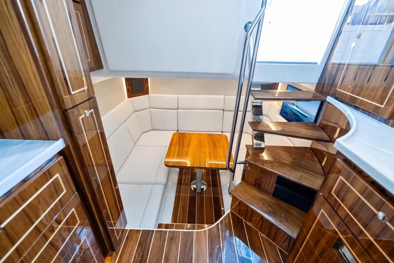  Yacht Photos Pics Luxurious interior of 2025 HCB 56 Suenos GIX yacht with wooden finishes and seating area.