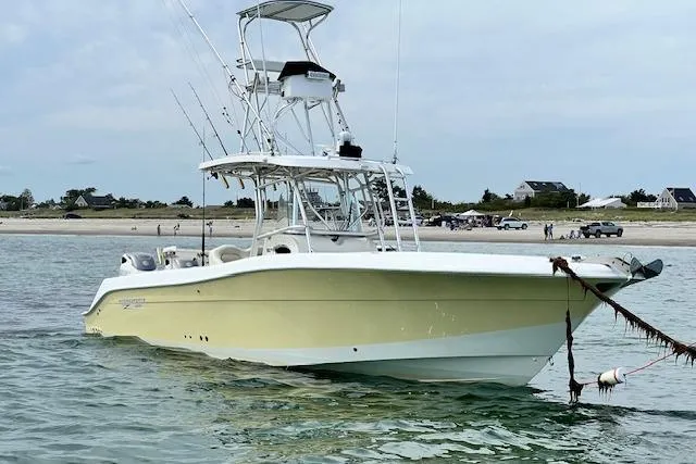 The Buck-a-neer Yacht Photos Pics 2005 Hydra-Sports Vector 3300 CC boat anchored near a sandy beach.