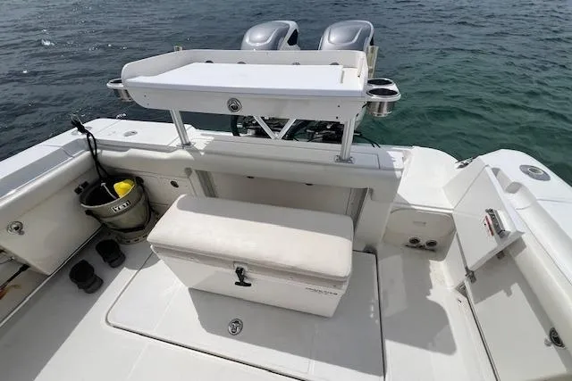 The Buck-a-neer Yacht Photos Pics 2005 Hydra-Sports Vector 3300 CC boat deck with seating and storage, on calm water.