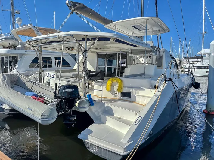 Jubilee Yacht Photos Pics 2015 Leopard 48 catamaran docked with dinghy and Suzuki outboard motor.