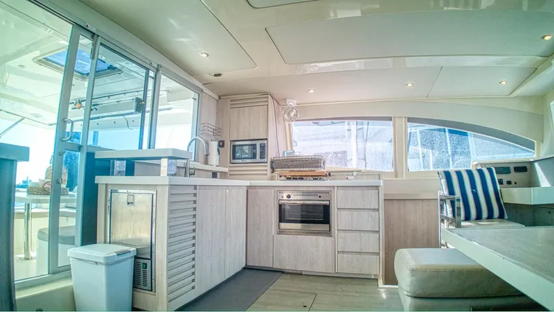 Jubilee Yacht Photos Pics Luxurious interior of 2015 Leopard 48 yacht with modern kitchen and seating area.