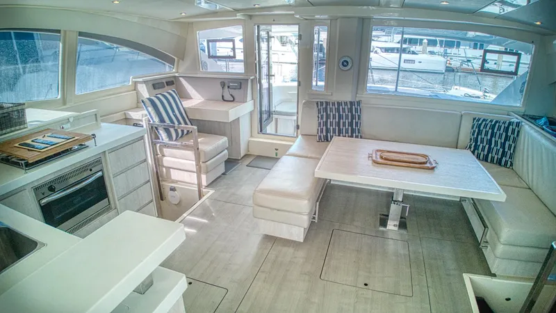 Jubilee Yacht Photos Pics Luxurious interior of a 2015 Leopard 48 yacht with modern kitchen and dining area.